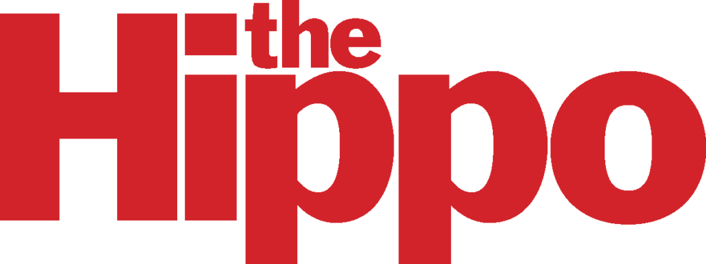 A red text graphic that says The Hippo