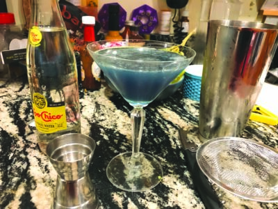 blue cocktail in a martini glass