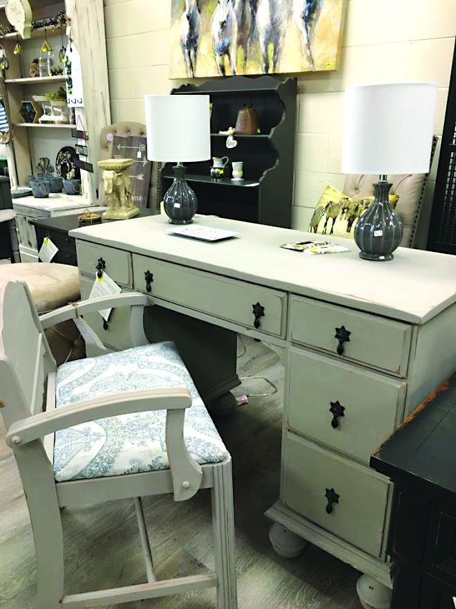 Light gray desk and bench chair in furniture shop