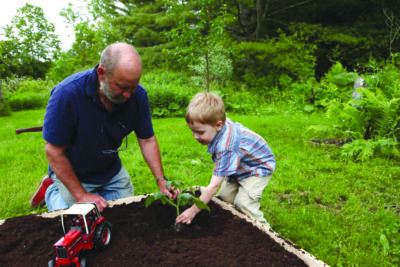 kid gardening with father