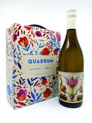 wine bottle next to box with flowers on it