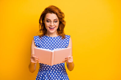 Photo of lady in blue dress holding an open book