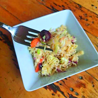 noodles and coleslaw in white square dish with fork