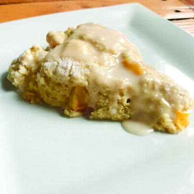 peach scone with glaze, on square plate