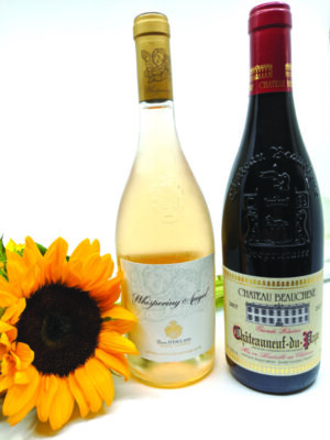 2 bottles of wine on white background with sunflower sitting beside them