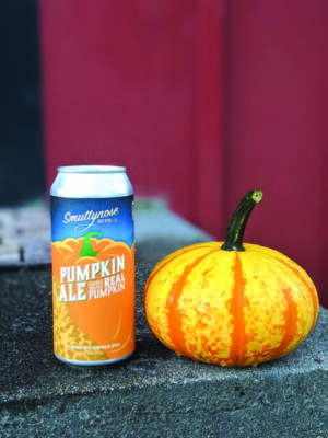 can of pumpkin ale sitting on counter beside small pumpkin