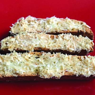3 biscotti covered in shredded cheese