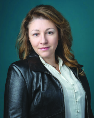 portrait of woman wearing button up shirt and black leather jacket