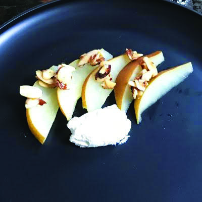sliced pears with walnuts and goat cheese in pan