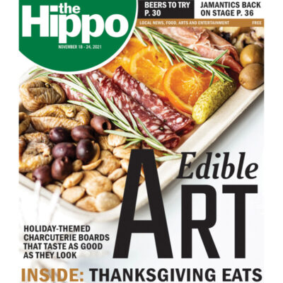 Hippo cover showing a charcuterie board filled with nuts, fruits, olives and sliced meats