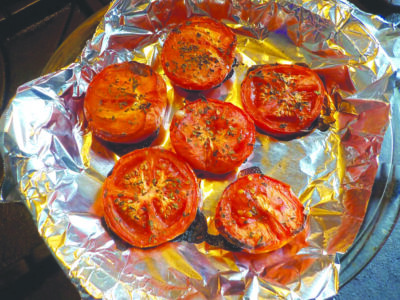 sliced tomatoes roasted on tinfoil