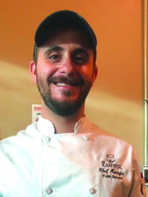 beared smiling man wearing chef's coat