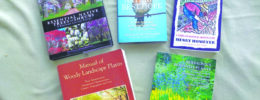 5 books about nature and gardening laid out on tablecloth