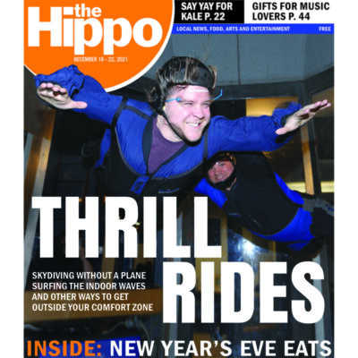 front page of newspaper featuring photo of indoor skydiving