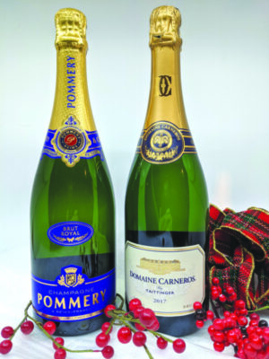 2 bottles of sparkling wine, plaid ribbon and red berries around them