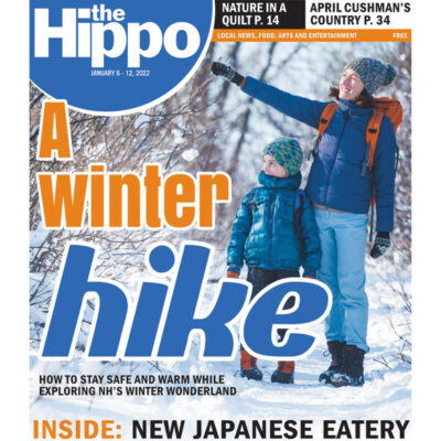 front page of Hippo newspaper featuring woman and young boy hiking in snow