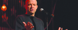 Jim Norton on stage in front of micrphone
