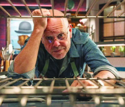 Alton Brown looking into oven