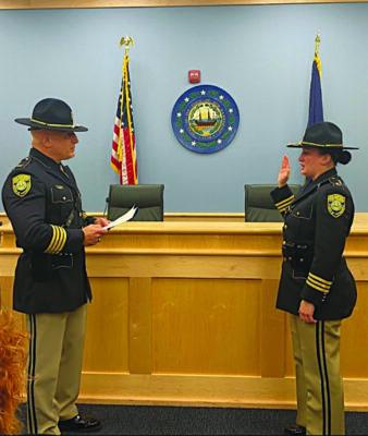 woman in uniform, raised hand, being sworn in for state law enforcement position