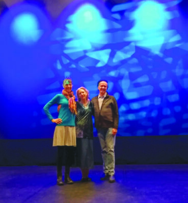 3 people standing on stage
