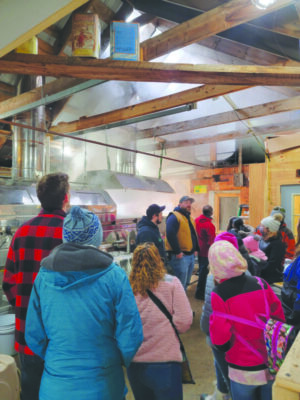 people on a tour at a sugar shack