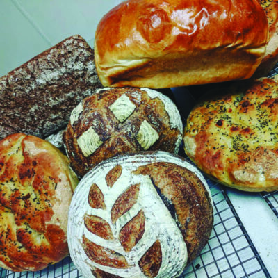 a variety of artisan breads sitting on cooling rack