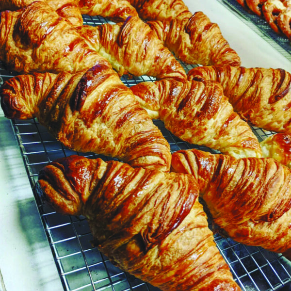croissants laid out on a cooling rack