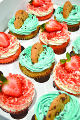 cupcakes topped with cookies and strawberries