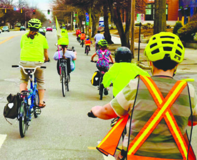 group of kids riding bikes through neighborhood