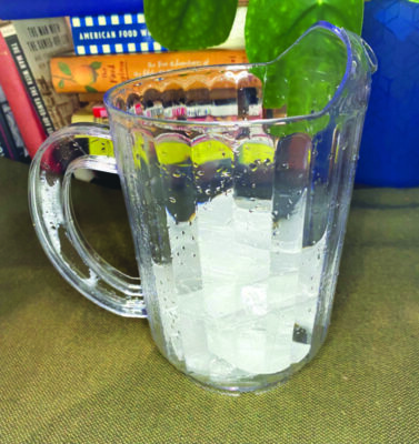 pitcher partly filled with ice cubes
