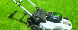 electric lawnmower on green grass
