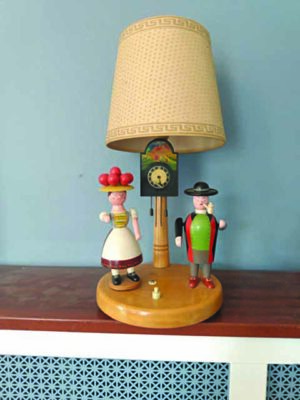 wooden lamp with a man and woman wooden figures on each side