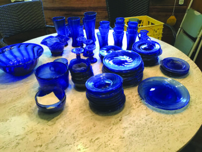 set of blue glassware, dishes, plates, glasses and candlesticks, on table