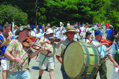 musicians marching in parade in front of crowd