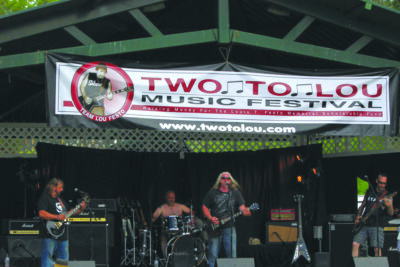 band playing on outdoor stage at charity music festival