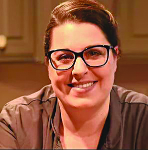 headshot of woman with glasses, smiling
