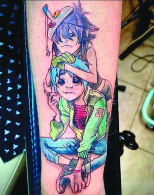 tattoo on arm of two cartoon children