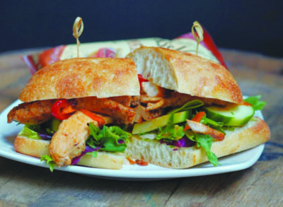 sandwich filled with chicken and vegetables on plate