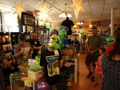 people browsing alien themed products inside at alien festival