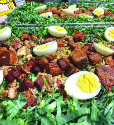 meat and hard boiled eggs on a bed of shredded greens