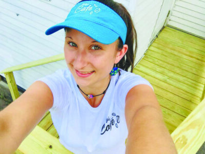 selfie from above of young woman wearing visor cap