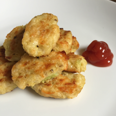 pieces of breaded cauliflower beside blob of ketchup