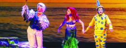 3 actors dressed as a seagull, a mermaid, and a fish, on stage in production of The Little Mermaid