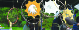crafted dream catchers hanging from artisan's tent at outdoor fair