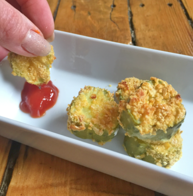 breaded pickles on plate with ketchup
