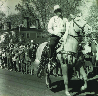 historica photograph of man riding horse in parade