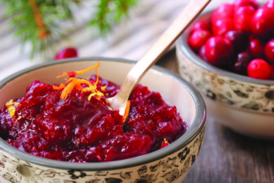 Homemade Cranberry Sauce served in a bowl on festive background