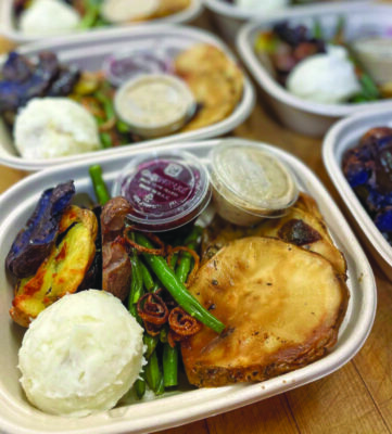 takeout containers filled with roasted vegetables