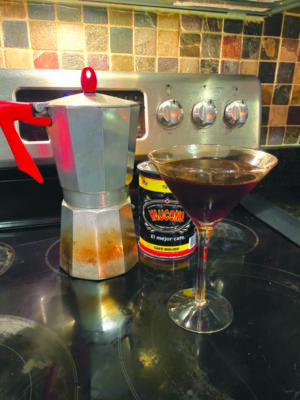 espresso martini on stove beside old fashioned coffee maker