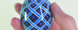Hand holding painted decorative egg ornament